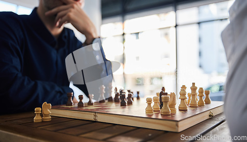 Image of Board game, chess and men playing at a table in office while thinking of strategy or plan. Male friends together to play, relax and bond with wooden icon for problem solving, competition or checkmate