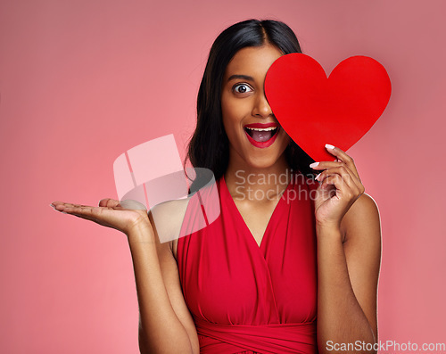 Image of Woman, happy surprise and heart, marketing mockup in red dress and promotion of love on pink background. Valentines Day advertising, female model in portrait and wow expression for branding in studio