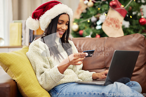 Image of Woman, laptop and credit card, online shopping for Christmas and fintech with payment for gift and bank app. Female person on sofa, internet banking on pc and finance, e commerce for holiday present