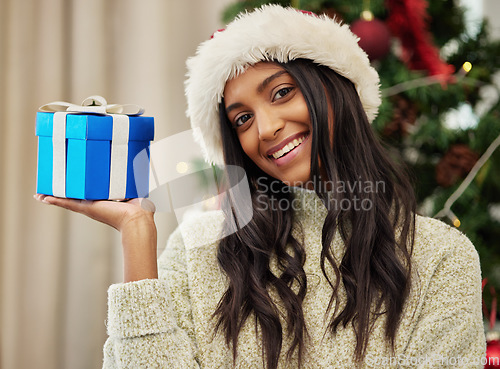 Image of Christmas, portrait or happy girl with a gift or box in present on a holiday celebration at home run winter. Wonder, smile or excited Indian woman with present with giveaway prize package in a house