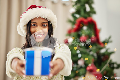 Image of Happy woman, Christmas and gift, celebrate holiday with happiness and smile in portrait. Special event, blue box with ribbon and female person at home giving a xmas present, package and festive