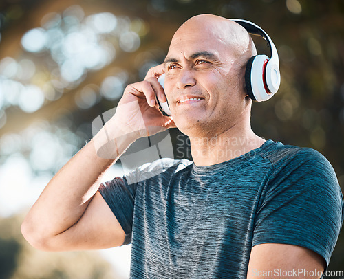 Image of Happy man, headphones and listening to music in nature for workout, training or exercise outdoors. Male person or mature runner smile with headset for audio streaming or online sound track outside