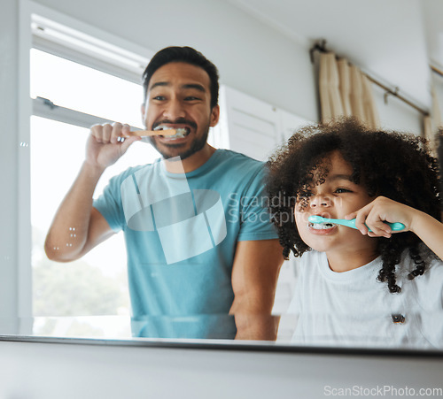 Image of Father, son and brushing teeth together in mirror, bathroom or home for hygiene, teaching or oral care. Man, child and toothbrush with foam, cleaning and learning for health, mouth and dental results