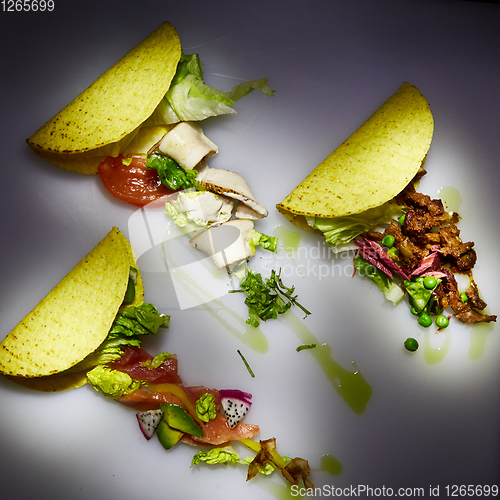 Image of Three different tacos with beef, chicken and salmon. View from above. With copy space.