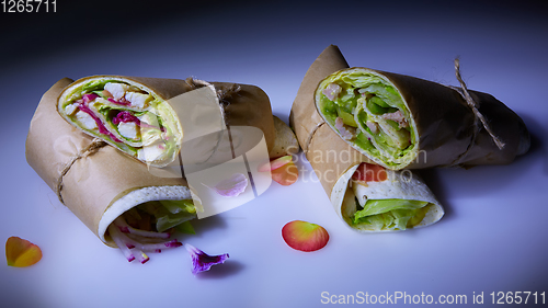 Image of Healthy lunch snack. Stack of mexican street food fajita tortilla wraps with grilled buffalo chicken fillet and fresh vegetables