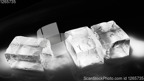 Image of Pieces of crushed ice cubes on black background.
