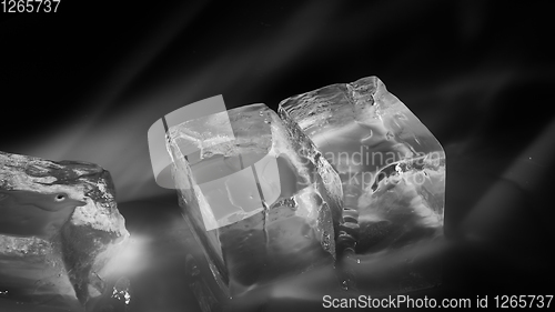 Image of Pieces of crushed ice cubes on black background.