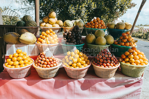 Image of tropical fruits in baskets on fruit market