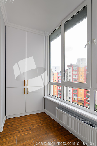 Image of Empty heated penthouse living room with floor to ceiling windows