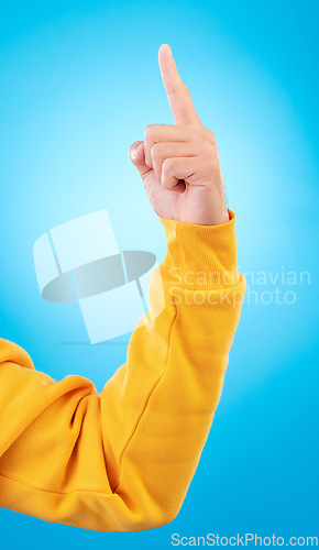 Image of Man, hands and pointing up finger for idea, solution or remember in memory against a blue studio background. Hand of male person in choice, decision or advertising plan guide, offer or opportunity