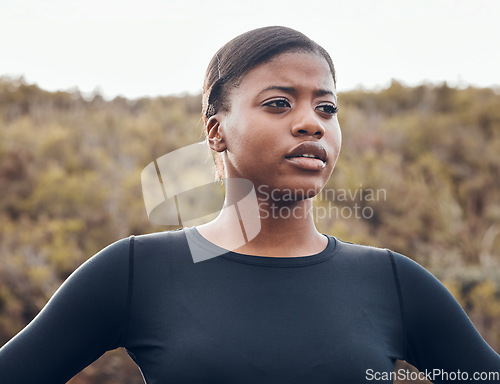 Image of Fitness, black woman and workout in nature forest for health wellness. Training or exercise, motivation or breathing and serious female athlete in sportswear for marathon practice in woods thinking