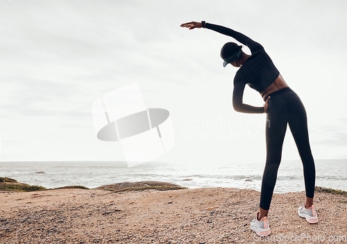 Image of Back of woman stretching by ocean for fitness in nature for exercise, marathon training and running. Sports, mockup space and female person stretch arms for warm up, cardio workout and body wellness