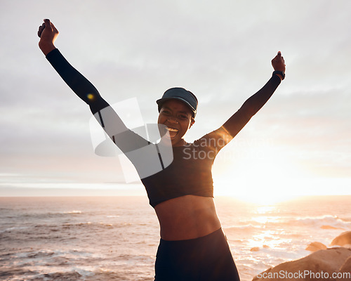 Image of Portrait of woman celebrate by ocean for fitness in nature for exercise, marathon training and running goals. Sports, sunset and female person with hands in air for winning, workout and wellness
