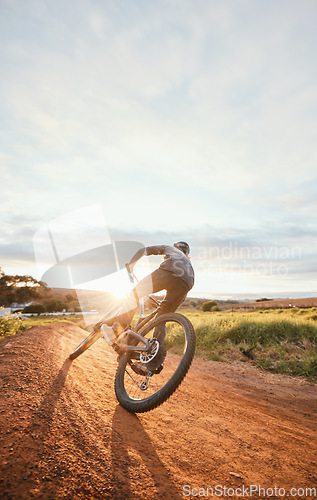 Image of Sports, morning and man of bicycle in nature for training, workout and exercise in countryside. Fitness, cycling and male person with mountain bike for adventure, freedom and adrenaline on dirt road