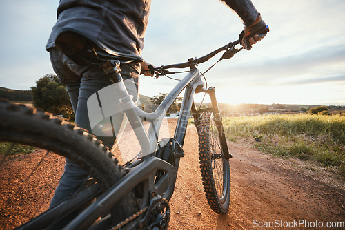 Image of Sports, cycling and closeup of bicycle in countryside for training, workout and exercise in nature. Fitness, cyclist and person with mountain bike for adventure, freedom and ride on outdoor dirt road