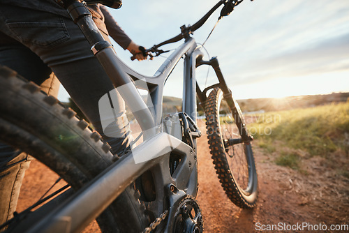 Image of Sports, mountain bike and closeup of bicycle in nature for hobby, workout and exercise in countryside. Fitness, cyclist and person cycling for adventure, freedom and adrenaline on outdoor dirt road