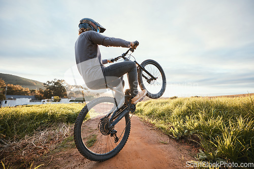 Image of Sports, cycling and man on bicycle in countryside for training, workout and exercise in nature. Fitness, cyclist and person on mountain bike for adventure, freedom and adrenaline on outdoor dirt road