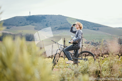 Image of Fitness, cycling and man on bicycle in nature for training, workout and exercise in countryside. Sports, cycling and male person with mountain bike for adventure, freedom and adrenaline on dirt road