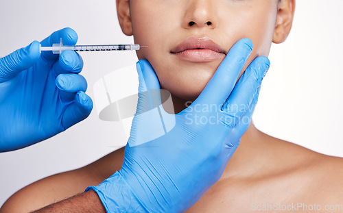 Image of Hands, injection and face with collagen, studio and cosmetic surgery for beauty, change and lip filler by white background. Surgeon, syringe and facial transformation for patient, service or skincare