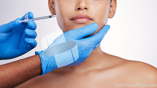 Image of Hands, injection and face with filler, studio and cosmetic surgery for beauty, change and lips by white background. Surgeon, syringe and facial transformation for patient, service and skin aesthetic