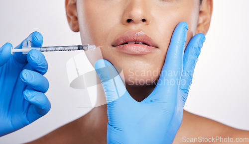 Image of Hands, needle and face with collagen, studio and cosmetics surgery for beauty, change and lip filler by white background. Surgeon, syringe and facial transformation for woman, service and skincare