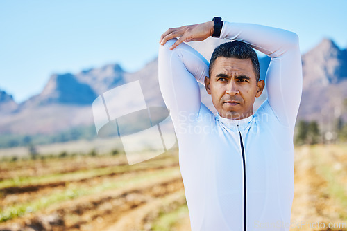 Image of Cyclist man, stretching arms or thinking of race, fitness or travel in nature for wellness by mountains. Warm up, countryside or healthy sports athlete ready to start training with active workout