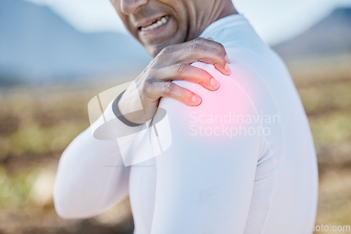 Image of Biker, hand or man with shoulder pain, injury or inflammation outdoors with torn muscle, strain or bruise. Cyclist, injured or sports athlete with accident, red glow or emergency in training practice