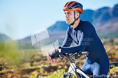 Image of Fitness, thinking or man cycling on a bicycle for training, cardio workout and exercise on mountain road. Relax, healthy recovery or tired sports athlete biker resting on a break or trail adventure