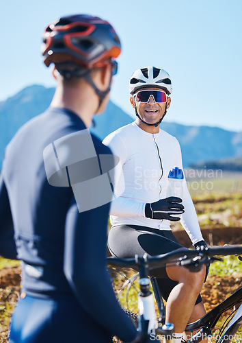 Image of Fitness, bike and friends drinking water in nature, taking a break from their cardio or endurance workout. Exercise, mountain and a man cyclist team in conversation while cycling in the countryside