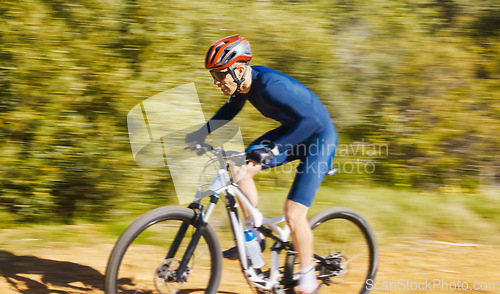 Image of Fitness, blur or man cycling on a bicycle for training, cardio workout and race exercise in nature. Speed motion, action or sports athlete riding a bike on path off road for freedom or challenge