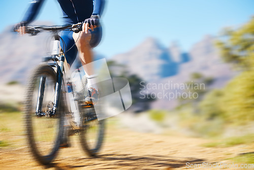 Image of Cycling, fitness and man on a bike in nature for extreme sports, race or training with motion blur. Bicycle, exercise and male cyclist riding on a dirt road with energy, adrenaline or speed challenge
