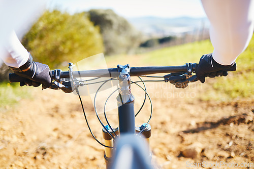 Image of Cycling, fitness and bike with hands of person in nature for training, sports or travel. Workout, exercise and wellness with closeup of cyclist and handlebar of bicycle on path for energy and freedom