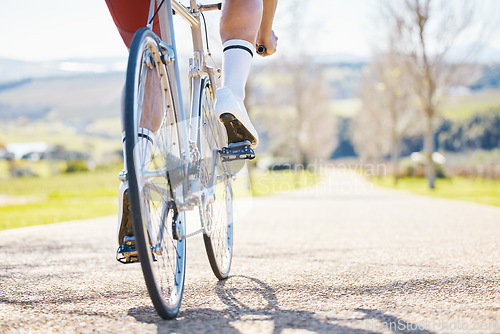 Image of Closeup, outdoor or cyclist with fitness, bicycle or training with sneakers, health or wellness. Feet pedal, athlete or cyclist for exercise in nature or performance with wheel, travel or countryside