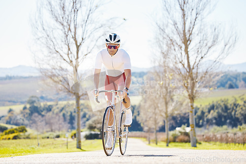 Image of Fitness, countryside or man cycling on a bicycle for training, cardio workout and exercise outdoors alone. Wellness, healthy or sports athlete riding a bike on a road or path for freedom or challenge