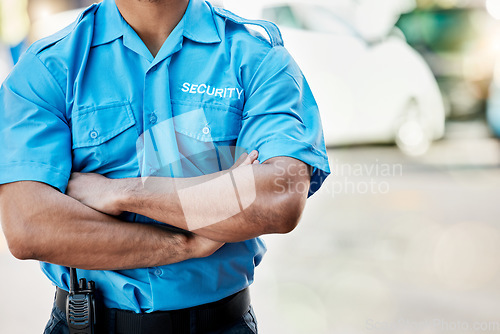 Image of Security guard, safety officer and man with arms crossed outdoor on street for protection and patrol. Law enforcement, confident and duty with a crime prevention male worker in uniform in the city