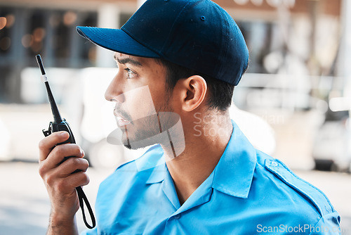 Image of Security guard, safety officer or man on walkie talkie on a street for protection, patrol or watch. Law enforcement, serious and communication with crime prevention male worker in uniform in the city