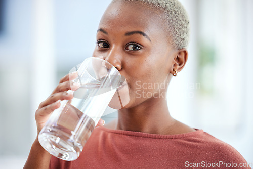 Image of Health, glass and portrait of a woman drinking water for hydration, wellness and liquid diet. Healthy, h2o and headshot of young African female person enjoying a cold beverage or drink at her home.