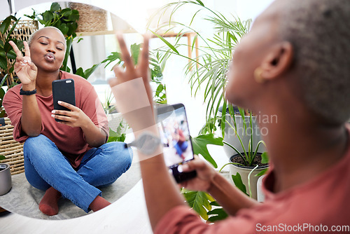 Image of Peace hands, selfie and black woman with mirror in a living room for photo, fun or text. Smartphone, hand sign and female social media influencer pose for profile picture, blog or vlog update at home