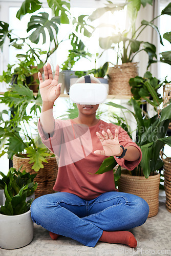 Image of Hands, virtual reality and headset of a woman at home for metaverse, 3d world or interaction. Black person with plants and vr glasses for ecology, ai or touch for video game or online experience