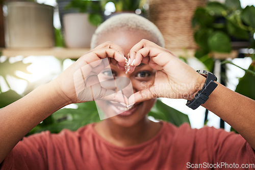 Image of Black woman, portrait and heart hands for love, sign or shape for health and wellness in eco friendly store. Face of happy African female person with loving emoji, symbol or gesture for natural care