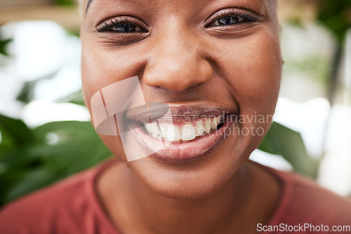 Image of Portrait, plants and teeth with a black woman gardener in her home for sustainability or green growth. Face, flare and smile with a happy young female person in a nursery for eco friendly gardening