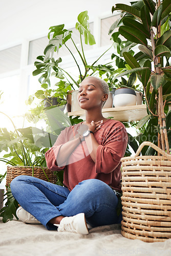 Image of Wellness, peace and woman breathing by plants for meditation in a natural greenhouse. Breathe, gratitude and young calm African female person with a relaxing zen mindset by an indoor nursery garden.