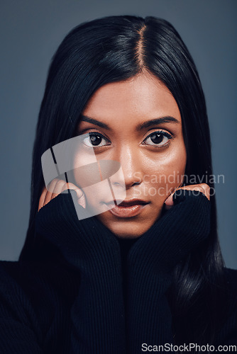 Image of Face, beauty touch and confidence of woman in studio isolated on a gray background. Serious portrait, natural skincare and Indian model with facial treatment for aesthetic, cosmetics and wellness