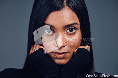 Image of Face, beauty touch and skincare of woman in studio isolated on a gray background. Serious portrait, natural and confident Indian model with spa facial treatment for aesthetic, cosmetics and wellness.