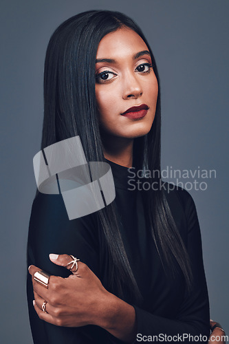 Image of Portrait, beauty and serious woman with makeup in studio isolated on a gray background. Face, skincare and cosmetics of Indian model with spa facial treatment for wellness, healthy skin and aesthetic