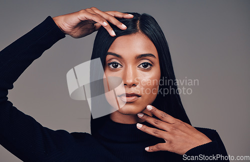 Image of Face, beauty and skincare of confident woman in studio isolated on a gray background. Serious portrait, natural and Indian model with spa facial treatment for aesthetic, healthy skin and cosmetics.