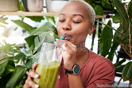Image of Health, diet and drink with black woman and smoothie for detox, breakfast and protein. Nutrition, food and weight loss with face of person and glass for green juice, vitamins and supplement