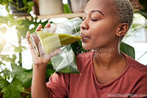 Image of Health, drink and detox with black woman and smoothie for diet, breakfast and protein. Nutrition, food and weight loss with face of person and glass for green juice, vitamins and supplement