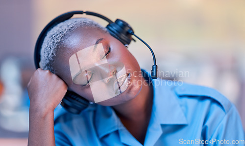 Image of Tired, call center and black woman sleeping with headset during telemarketing work at night. Contact us, burnout and African customer service employee with fatigue while in an office for consulting