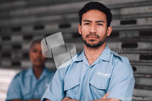 Image of Portrait, security or safety and a serious man arms crossed with a black woman colleague on the street. Law enforcement, focus and duty with a crime prevention unit working as a team in the city